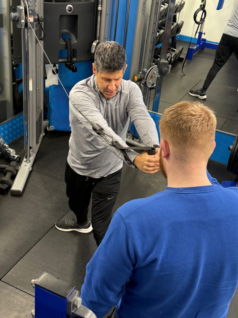 Personal Trainer for Golfers Hale & Altrincham | Soma Fitness Client performing rotational strength and power training with a personal trainer at Soma Fitness near Hale