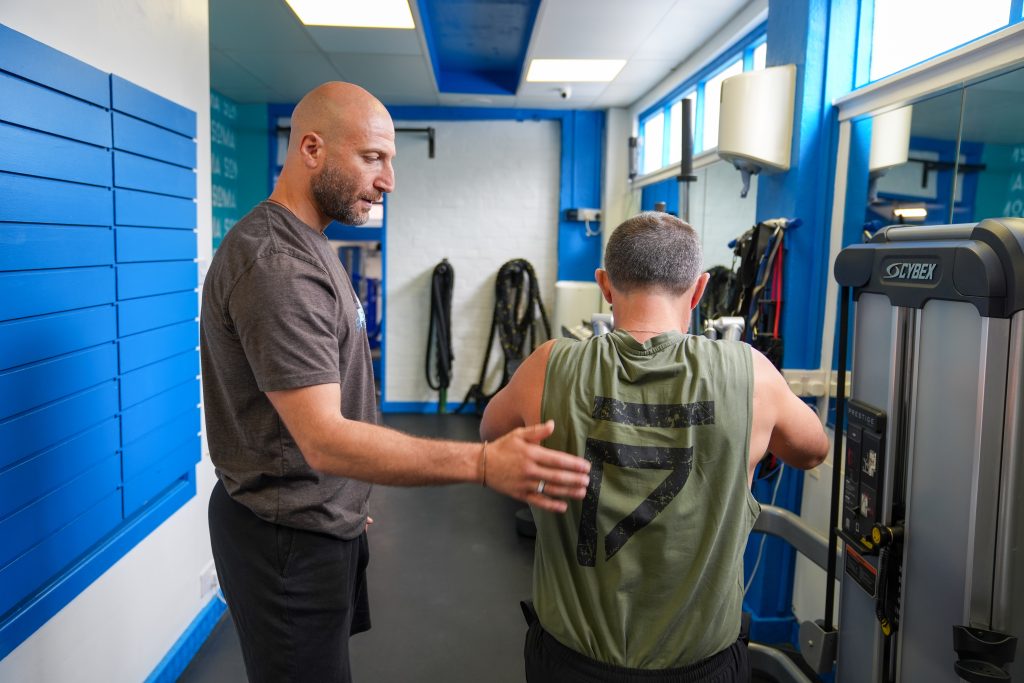 How to Get Stronger Safely | Personal Training Personal trainer coaching a client through strength training at Soma Fitness in Altrincham